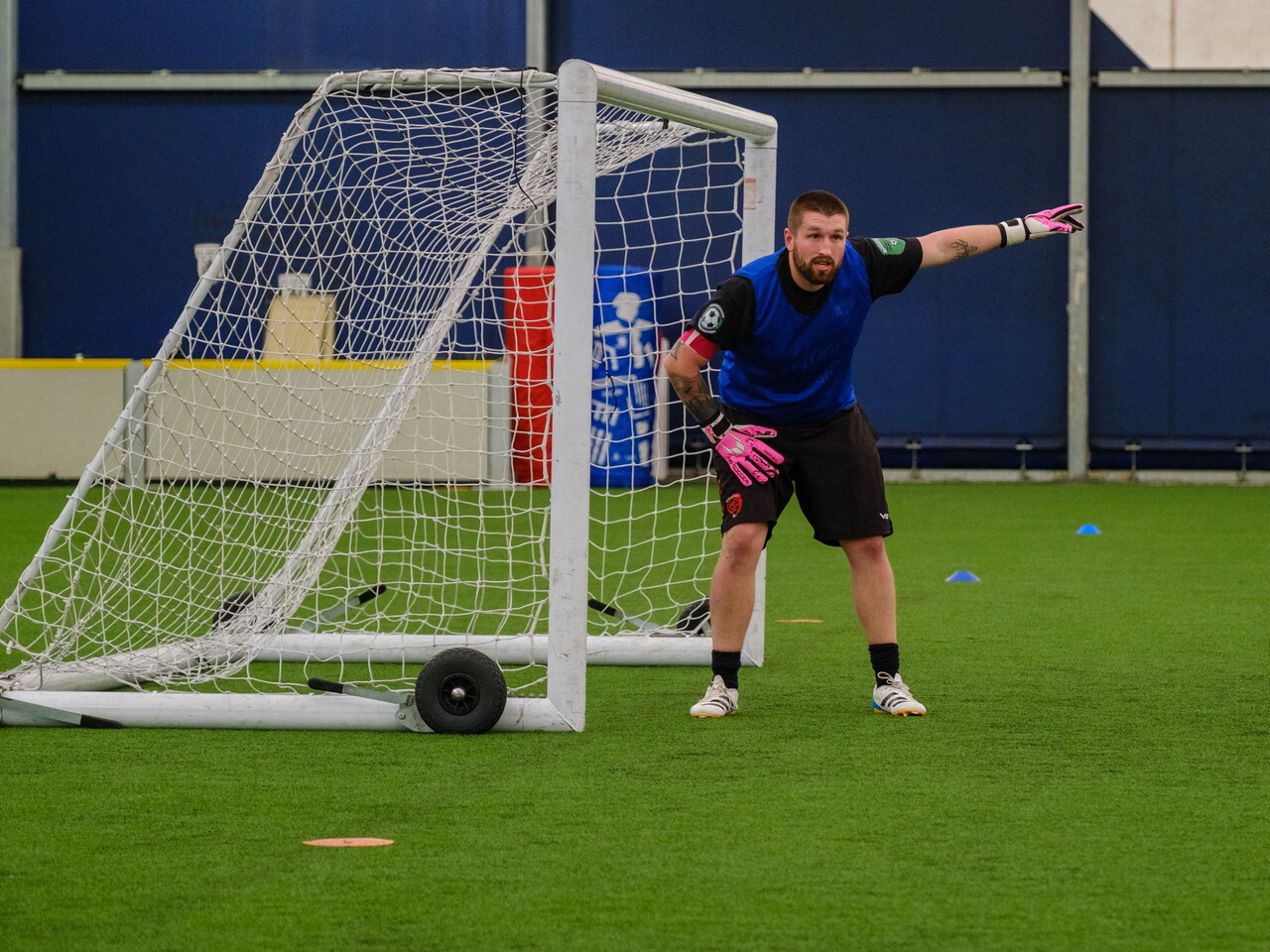 Moore than Cancer goalkeeper signalling out to his left.