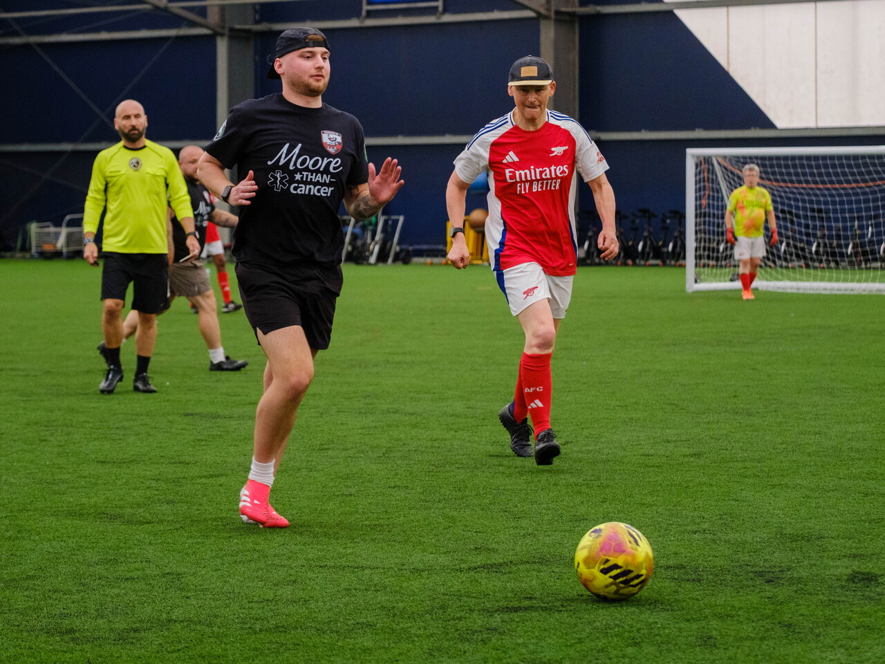 Moore than Cancer and Arsenal player chasing down the ball.