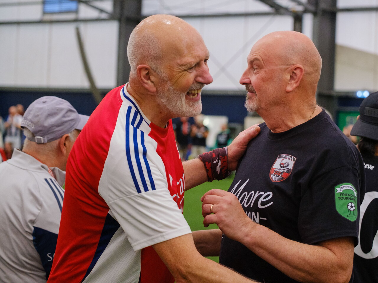 Close-up of Arsenal and Moore than Close players embracing after the match