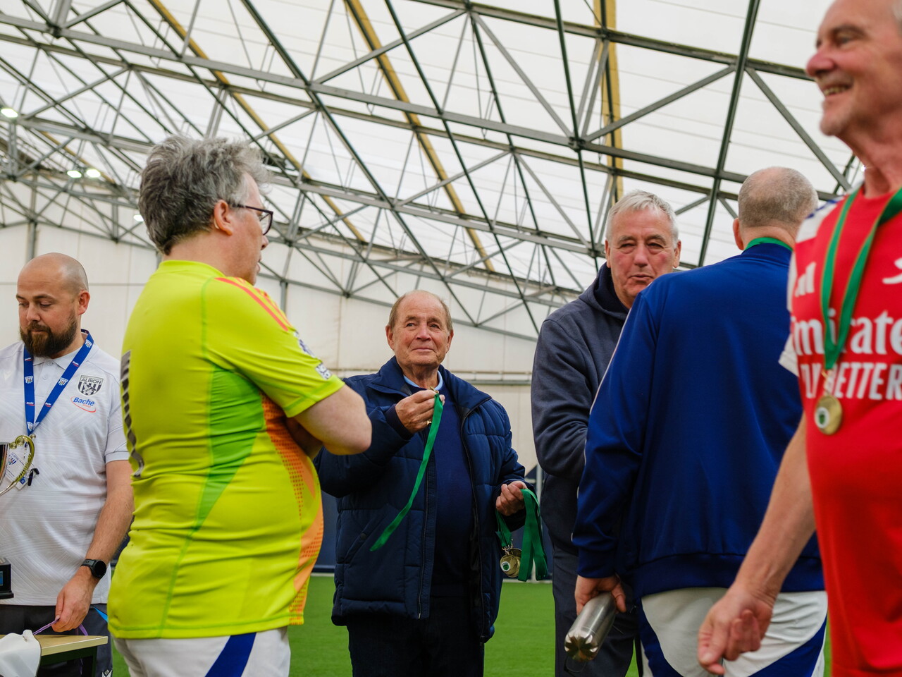 Micky Fudge awarding medals to runners-up Arsenal players.