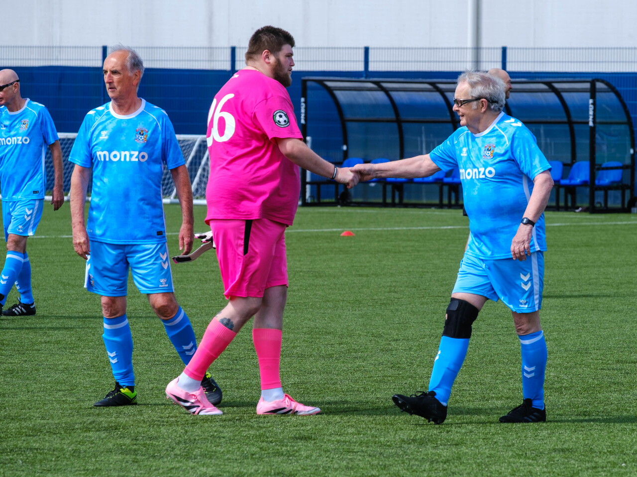 Sky Blue in the Community and Moore than Cancer players shaking hands after the game.