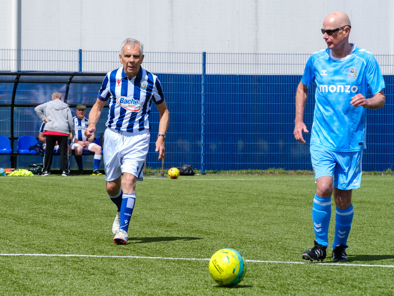 Sky Blue in the Community and Cancer Kickers player chasing the ball.