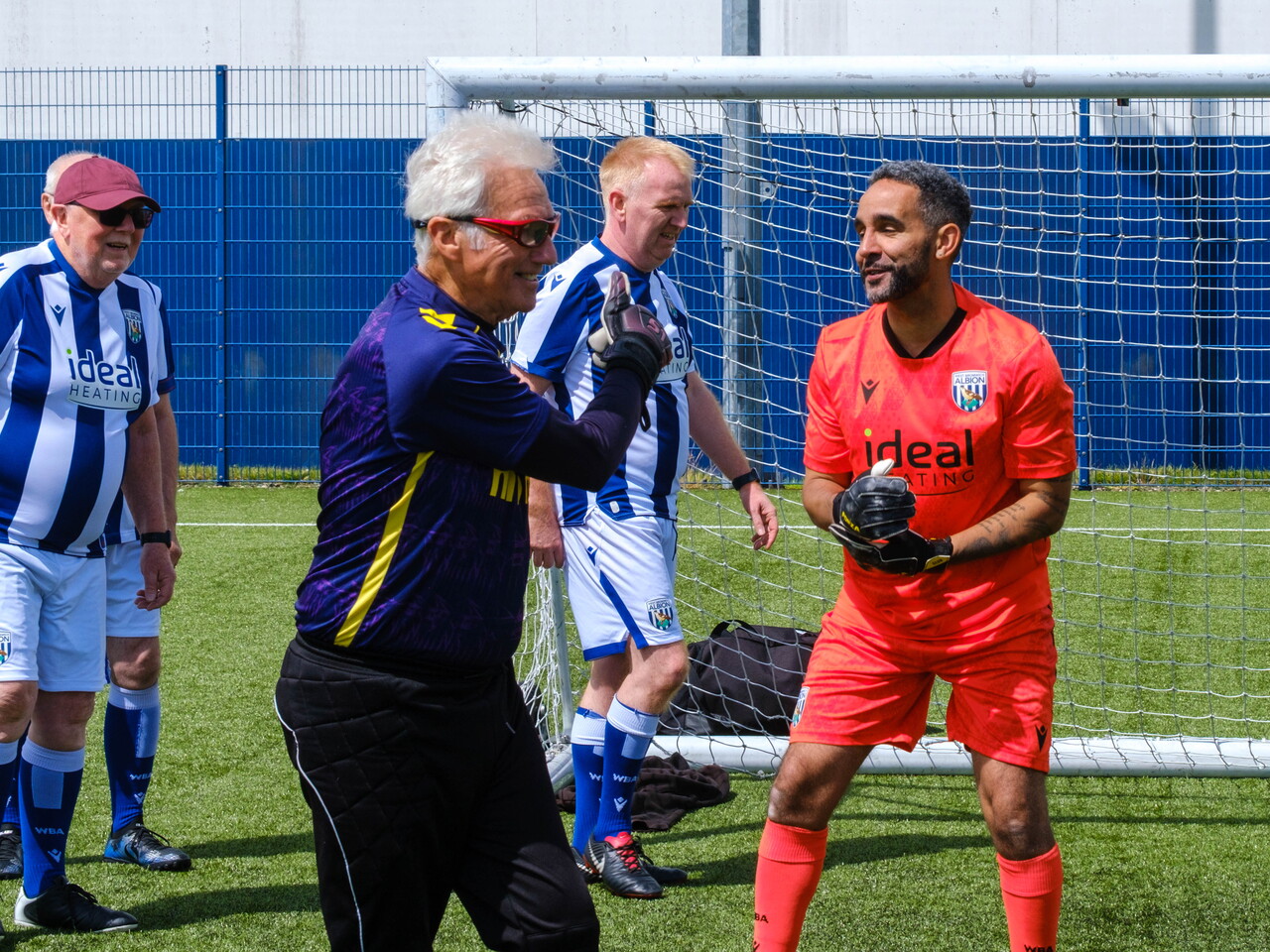 Close-up of Sky Blue in the Community goalkeeper and Cancer Kickers players at the conclusion of the game.