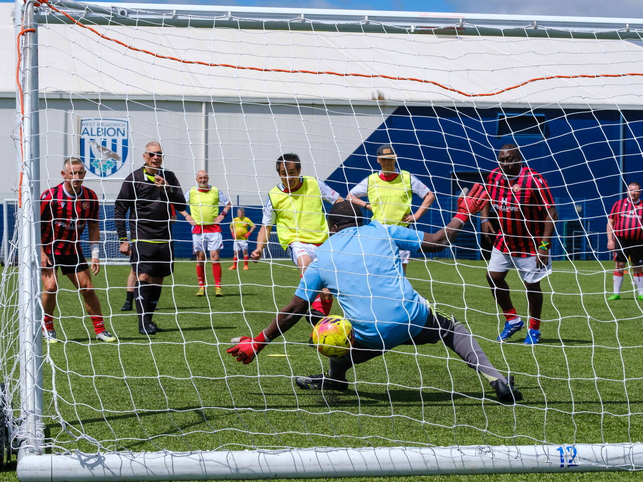 Arsenal penalty hitting the net, beating the Beat the Block keeper from behind the goal.