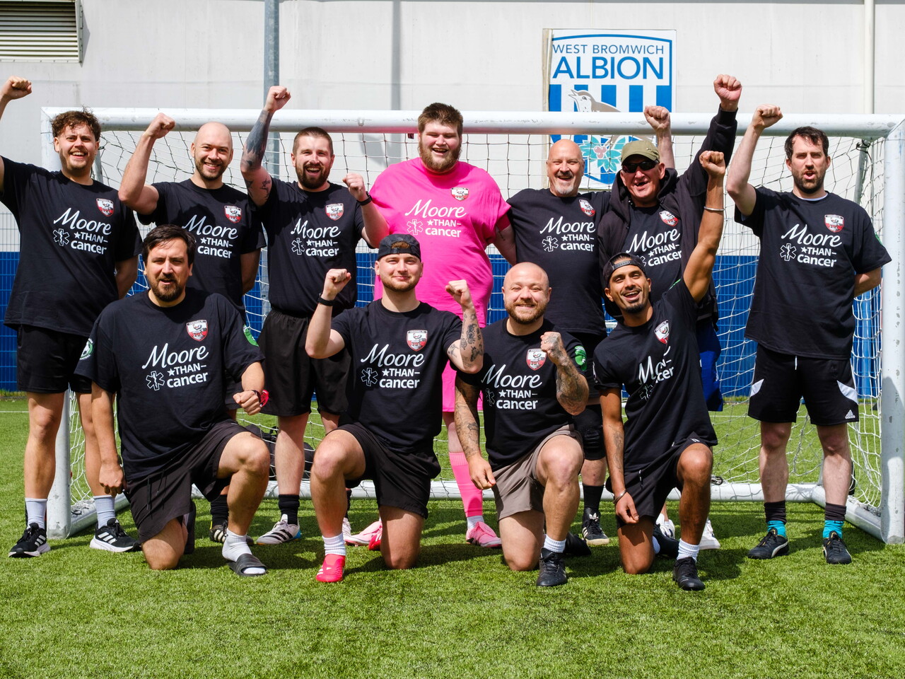 Moore Than Cancer team photo in front of the goal.