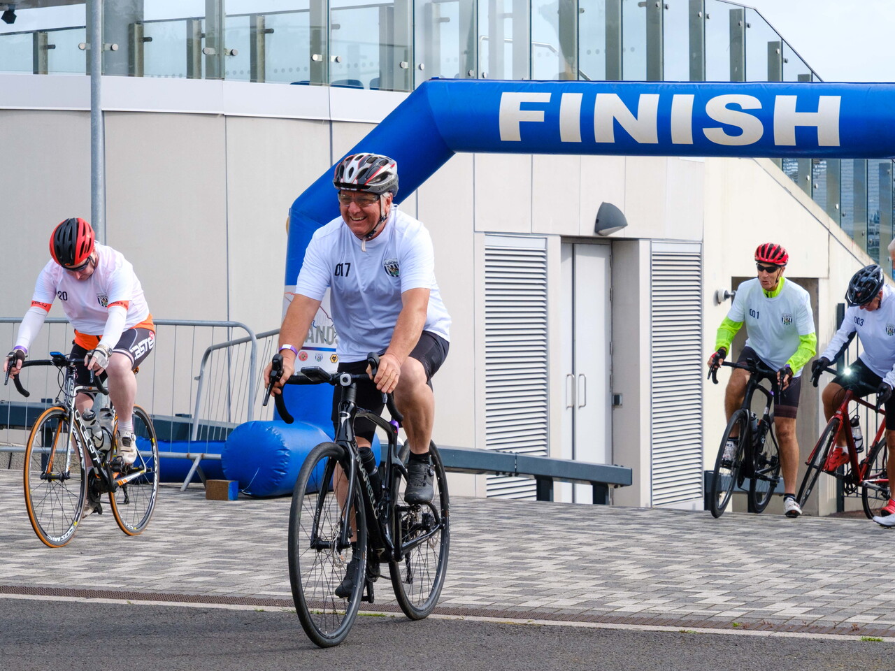  Cyclists begin their ride beneath an arch as they start the challenge.