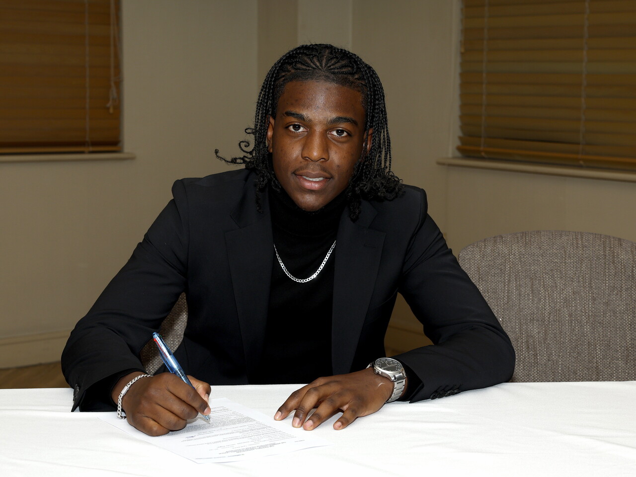 A photo of Albion youngster Tyrell Hutchinson signing his scholarship deal ahead of the 2026/27 campaign
