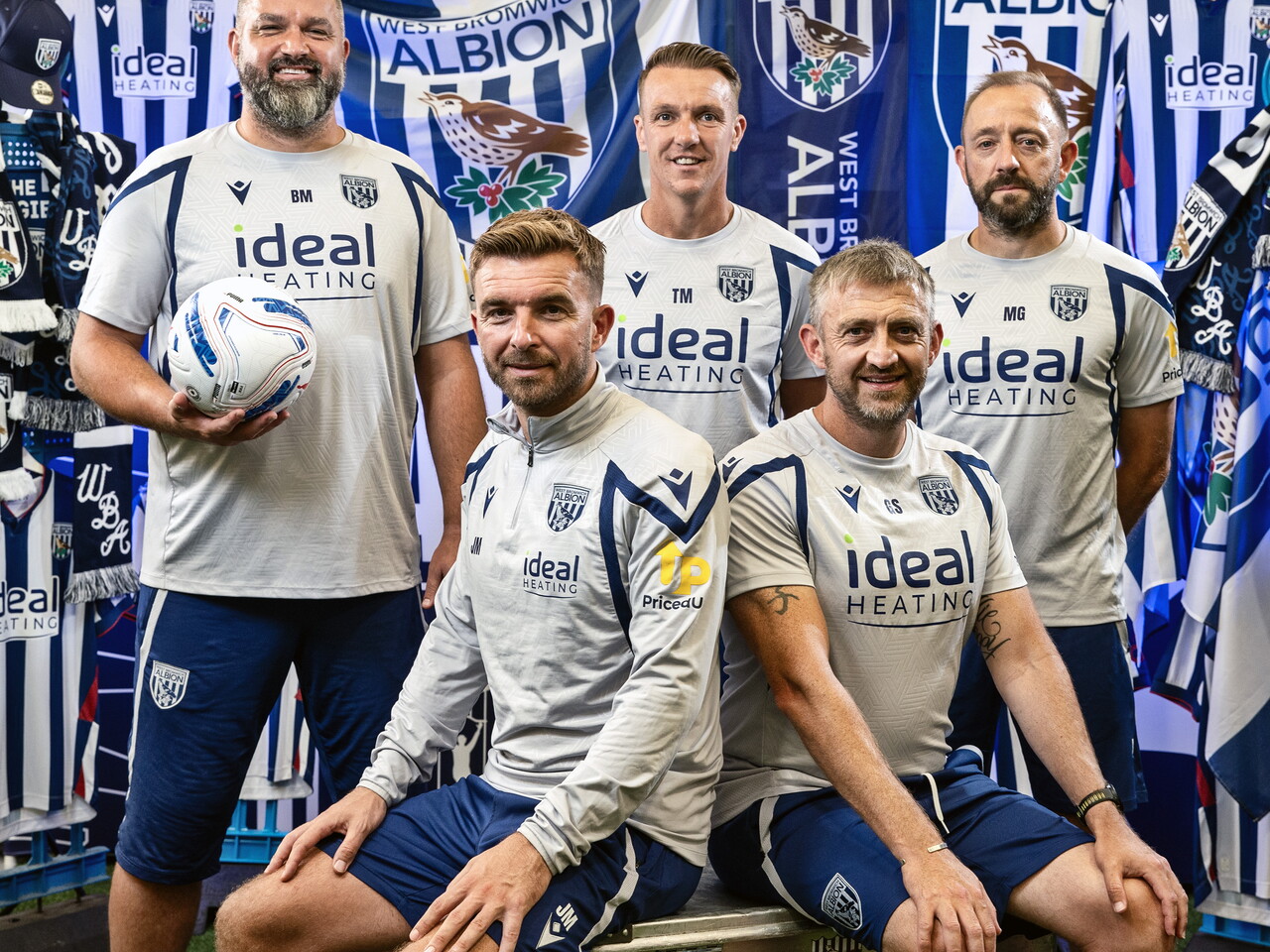 James Morrison sat in front of an Albion back drop with plenty of WBA branding with his coaching staff, consisting of Boaz Myhill, Tony McMahon, Matt Gill and Gavin Strachan