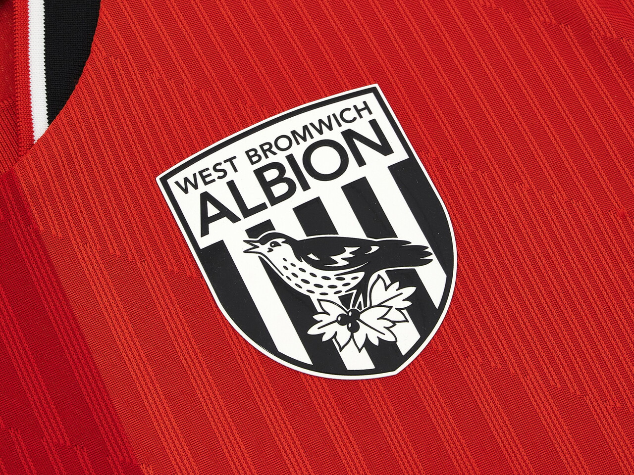An image of a small detail on Albion's 2026/27 red away kit 