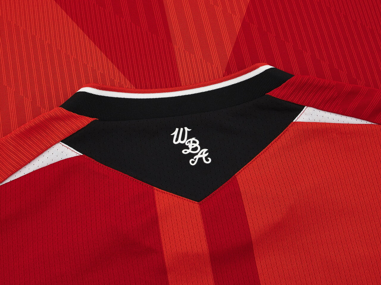 An image of a small detail on Albion's 2026/27 red away kit 