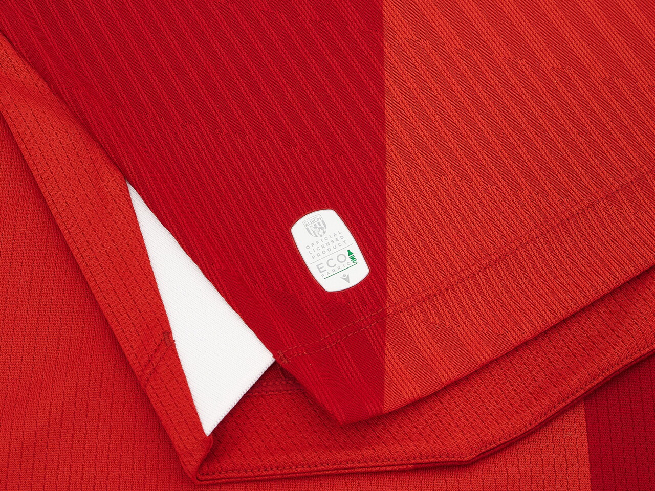 An image of a small detail on Albion's 2026/27 red away kit 