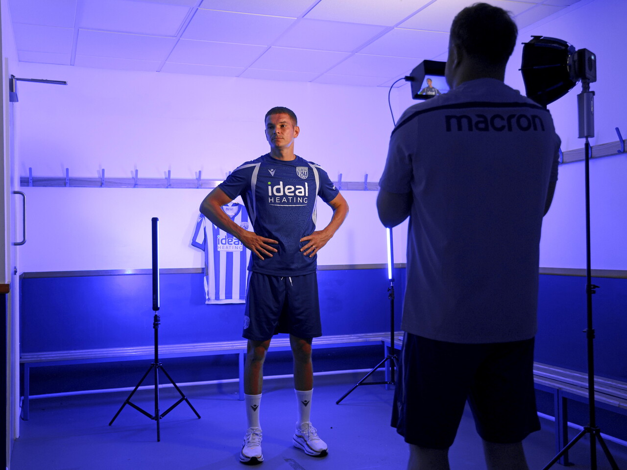 Conor Townsend looking at a video camera while stood in a changing room