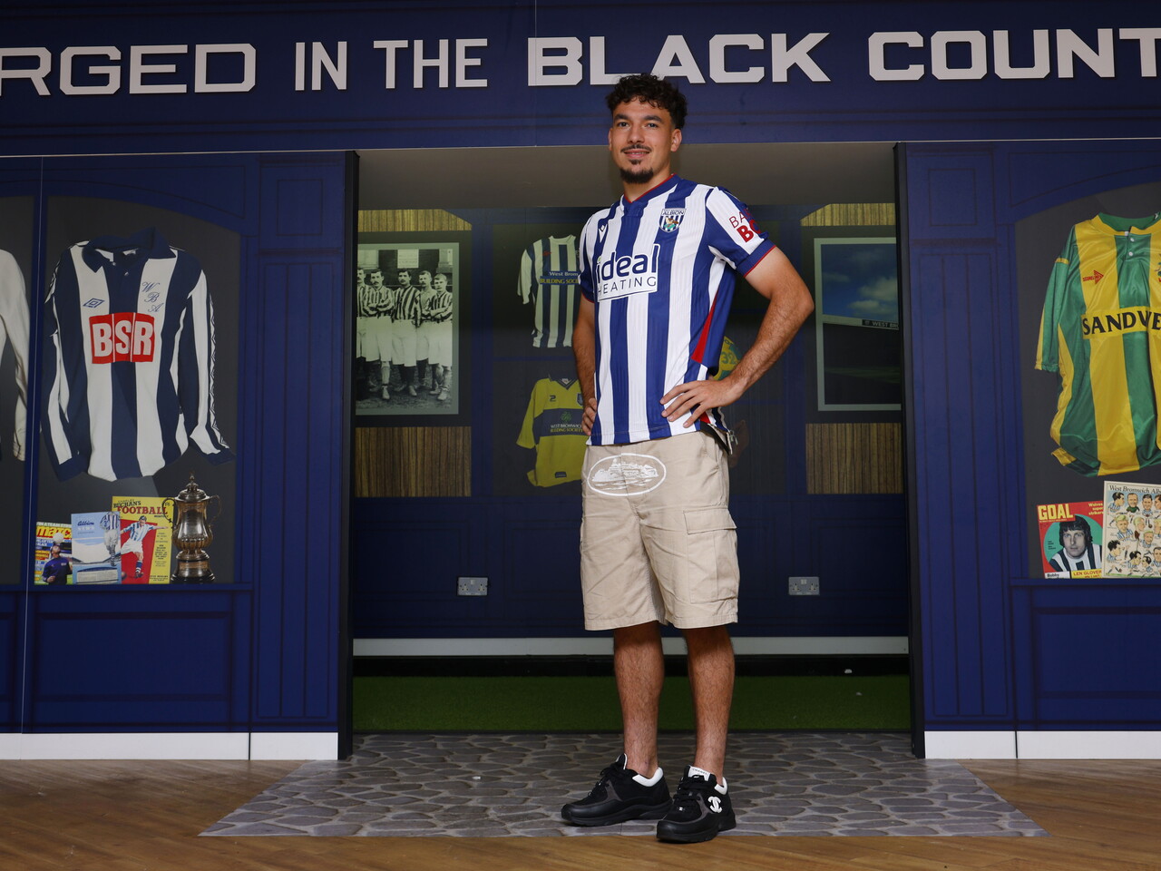 Nolan Galves stood in the home shirt in front of WBA historic branding 