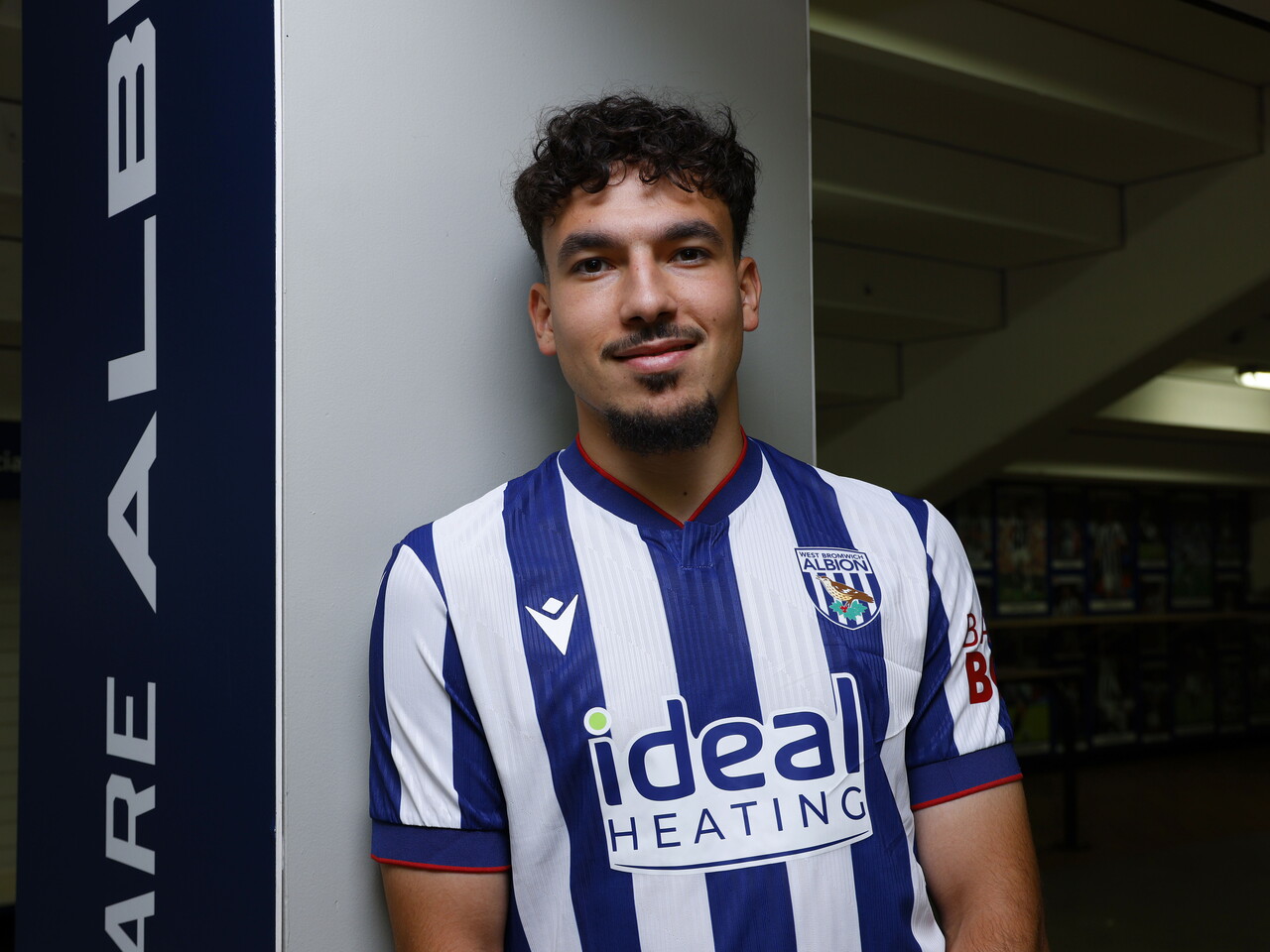Nolan Galves smiling at the camera while stood in the home kit 
