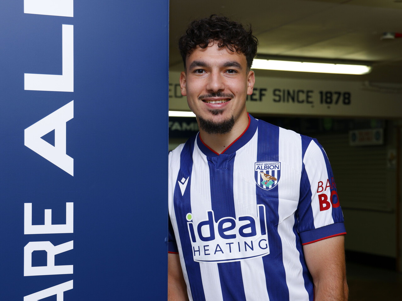 Nolan Galves smiling at the camera while stood in the home kit 