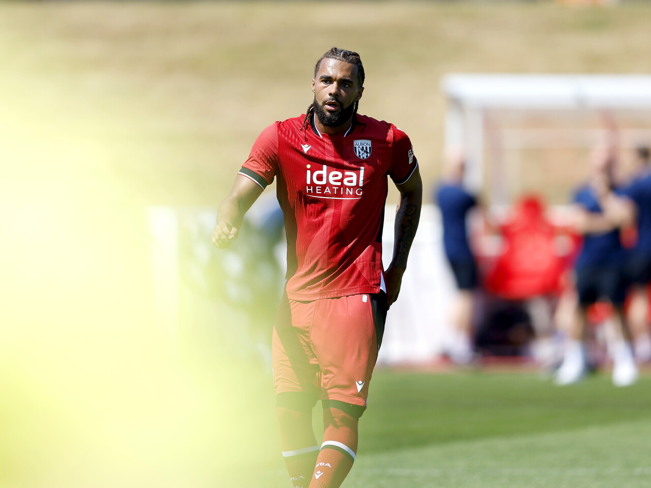 Albion in action against Sheffield Wednesday in pre-season, in red away colours.