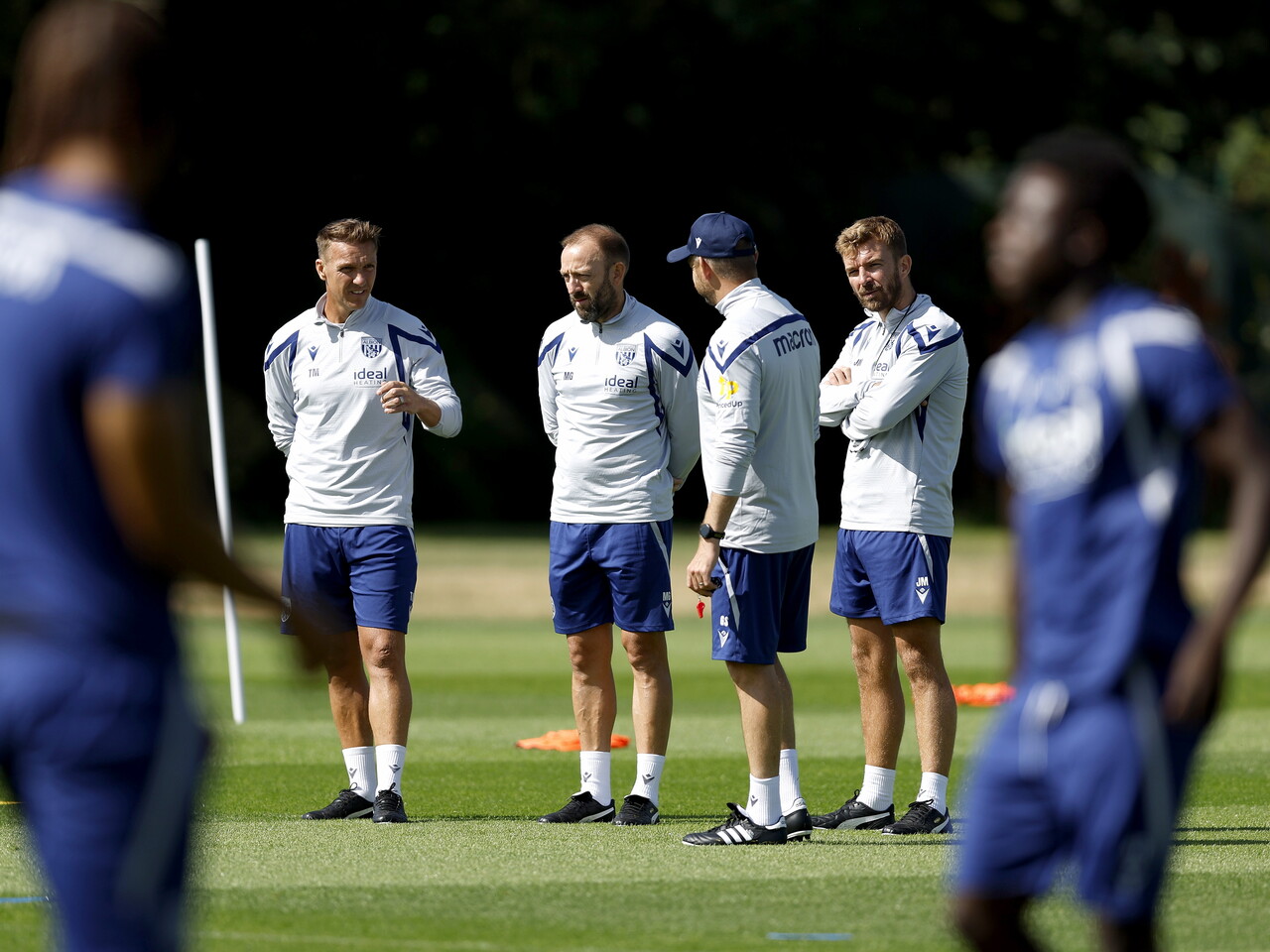 James Morrison chatting to his first-team coaching staff in the middle of a training session