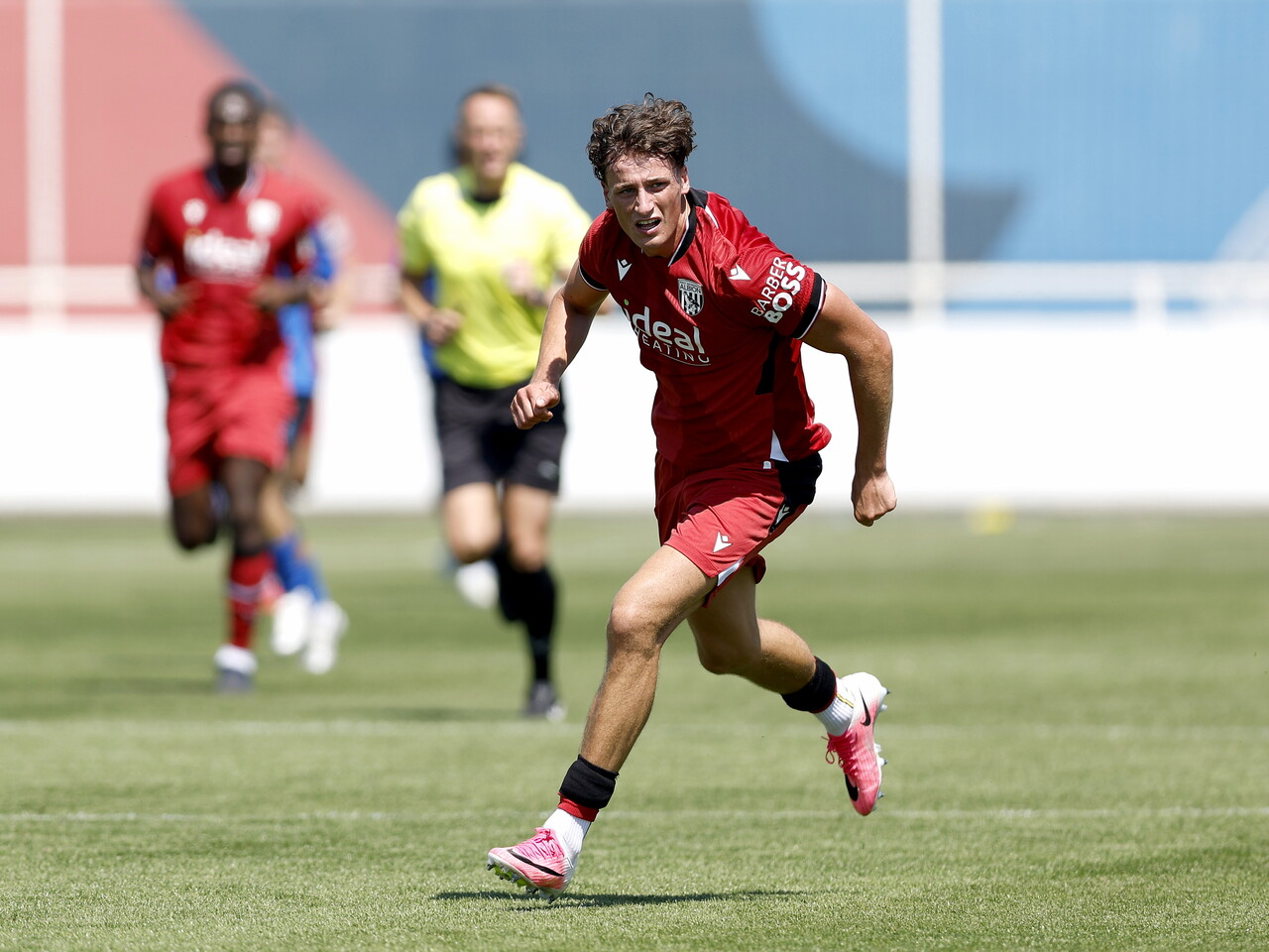 Albion in action against Sheffield Wednesday in pre-season, in red away colours.