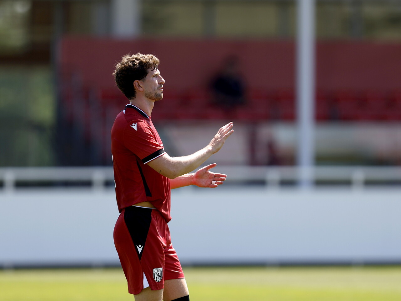 Albion in action against Sheffield Wednesday in pre-season, in red away colours.
