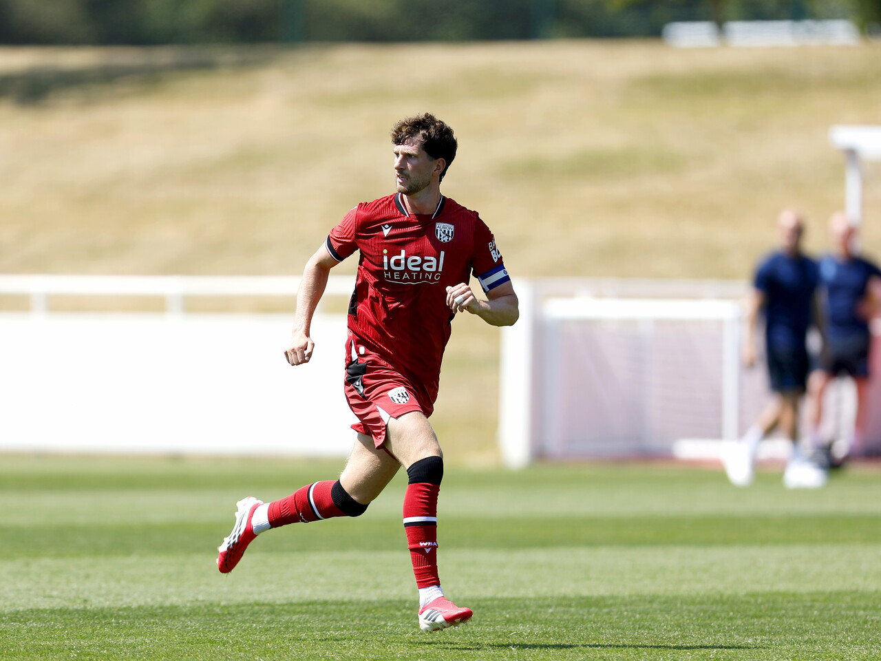 Albion in action against Sheffield Wednesday in pre-season, in red away colours.