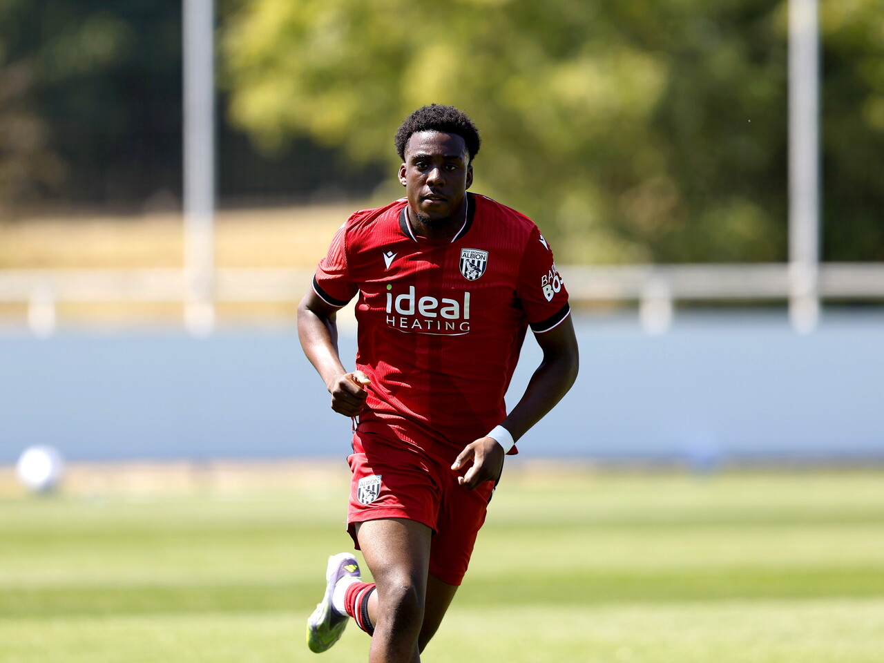 Albion in action against Sheffield Wednesday in pre-season, in red away colours.