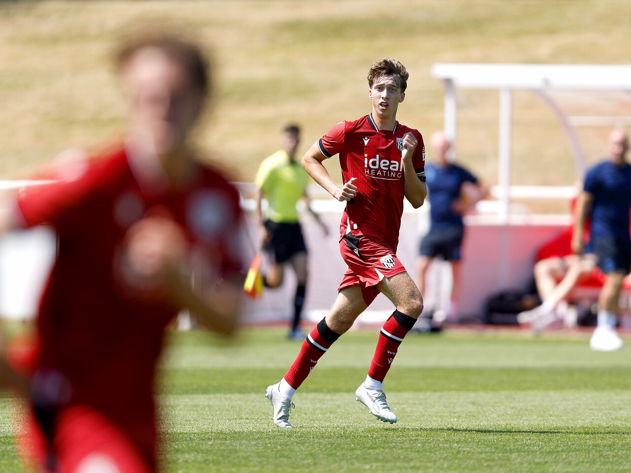 Albion in action against Sheffield Wednesday in pre-season, in red away colours.