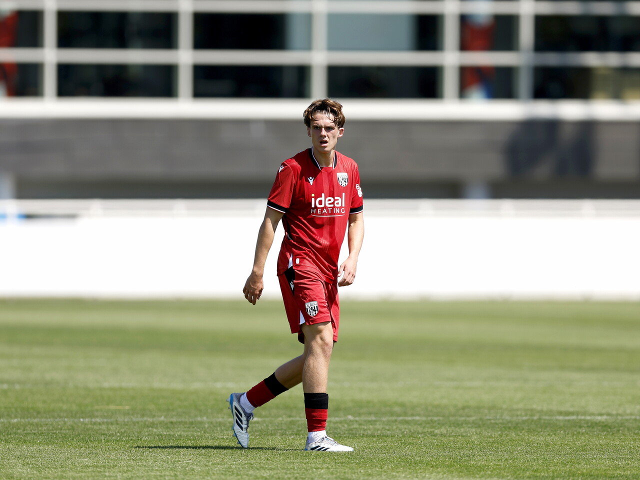Albion in action against Sheffield Wednesday in pre-season, in red away colours.