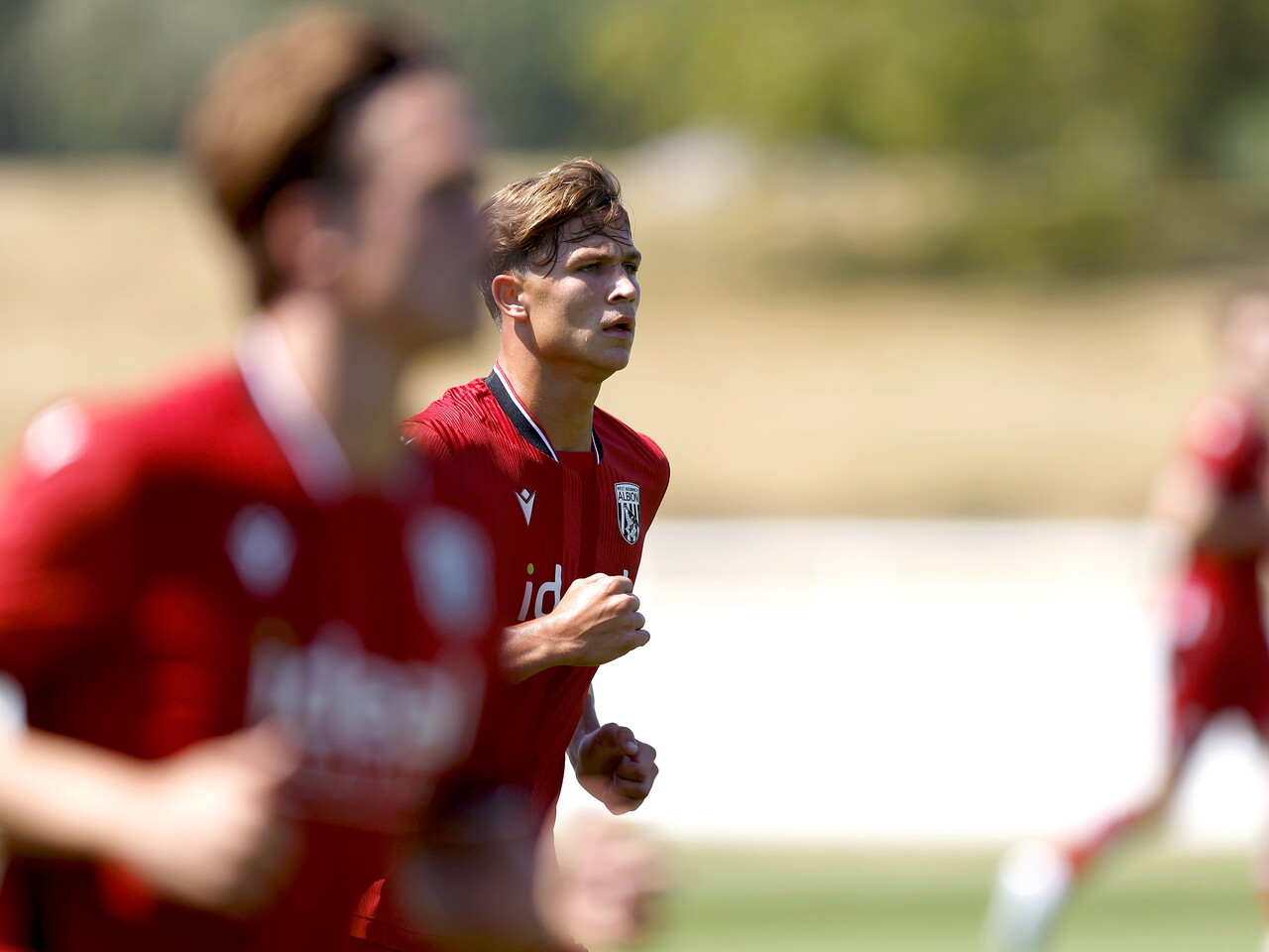 Albion in action against Sheffield Wednesday in pre-season, in red away colours.