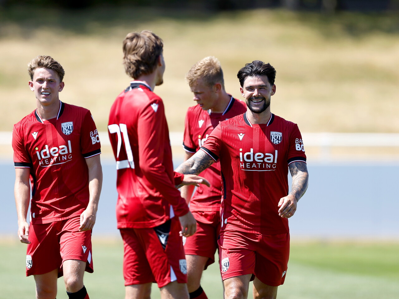 Albion in action against Sheffield Wednesday in pre-season, in red away colours.