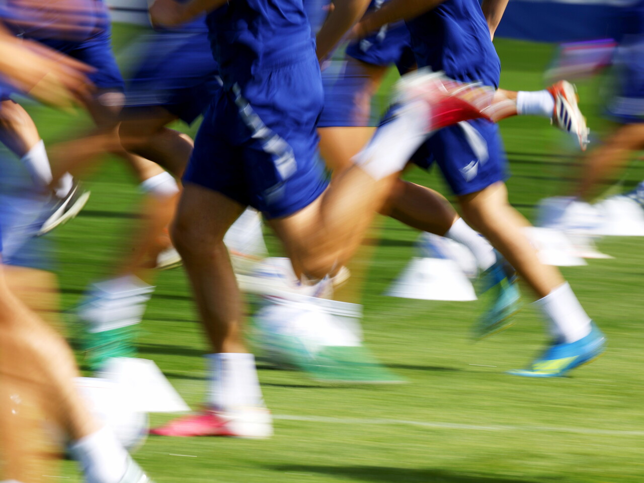 A shot of several pairs of legs running forward during a training session 