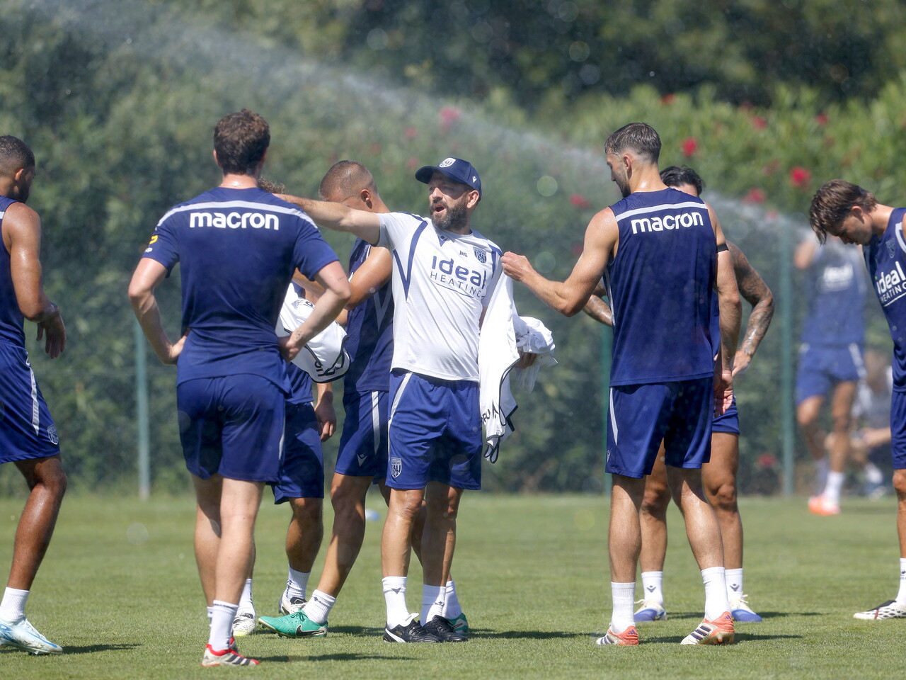 Matt Gill handing out instructions to several WBA players on the training pitch