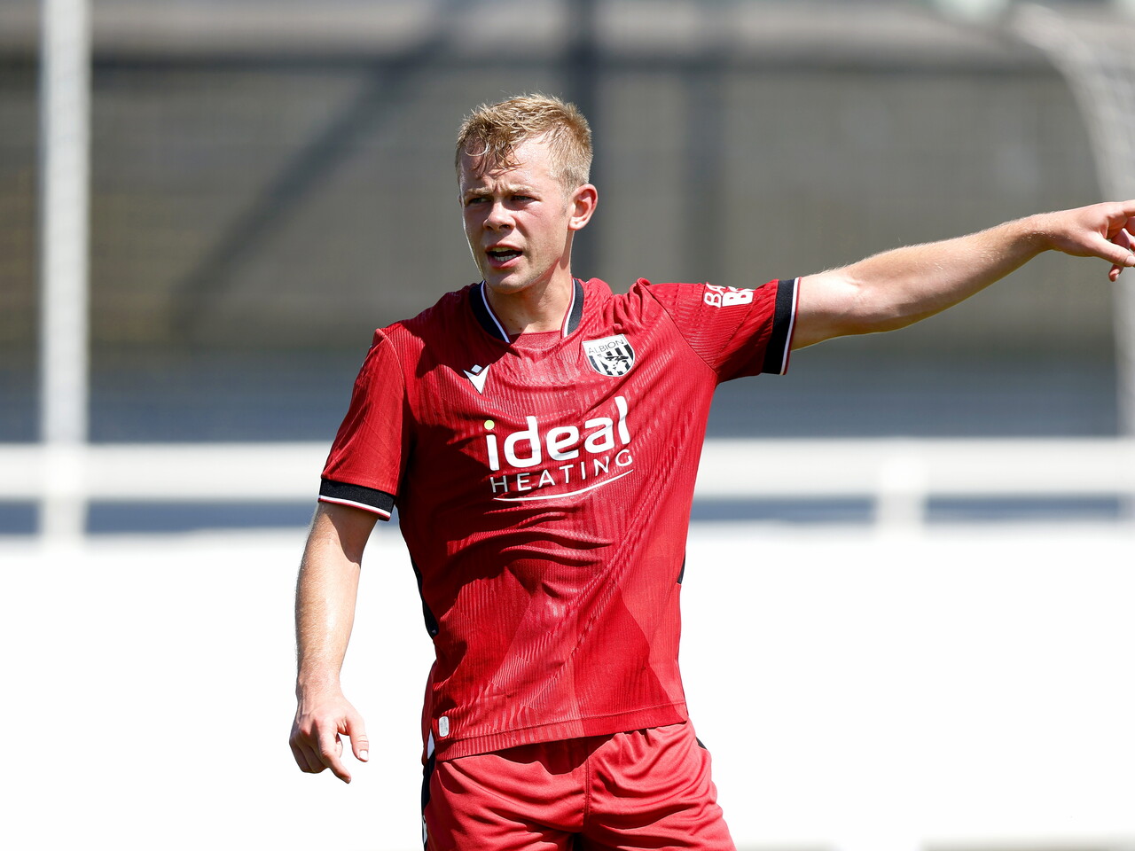 Albion in action against Sheffield Wednesday in pre-season, in red away colours.