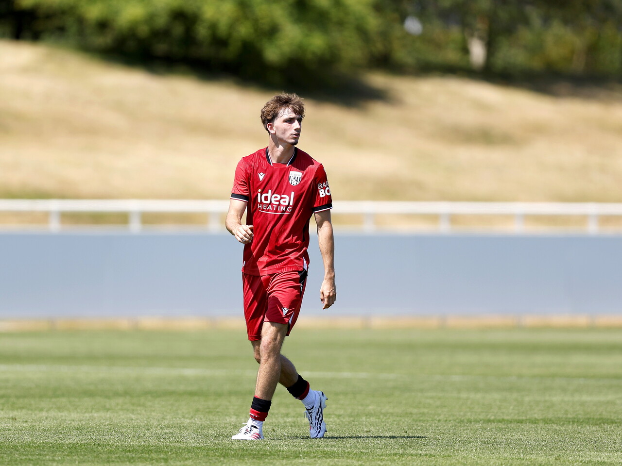 Albion in action against Sheffield Wednesday in pre-season, in red away colours.