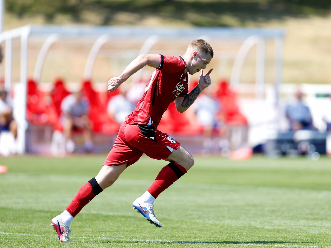 Albion in action against Sheffield Wednesday in pre-season, in red away colours.