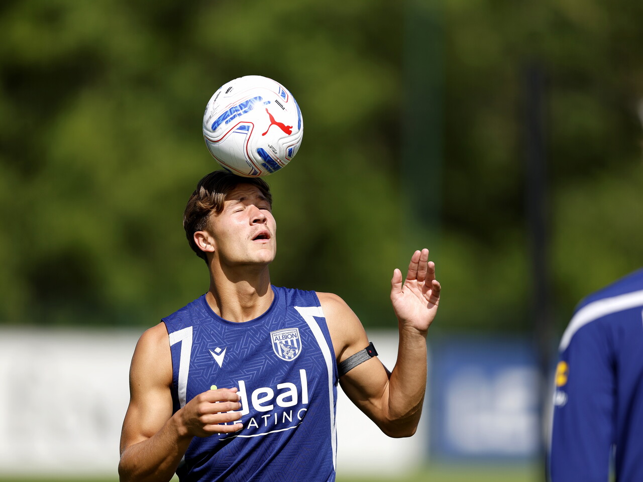 Cole Deeming balancing the ball on his head during a training session 