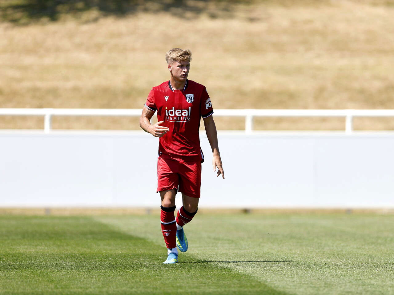 Albion in action against Sheffield Wednesday in pre-season, in red away colours.