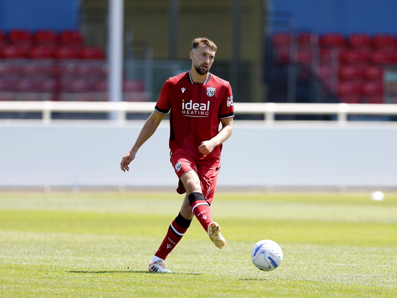 Albion in action against Sheffield Wednesday in pre-season, in red away colours.