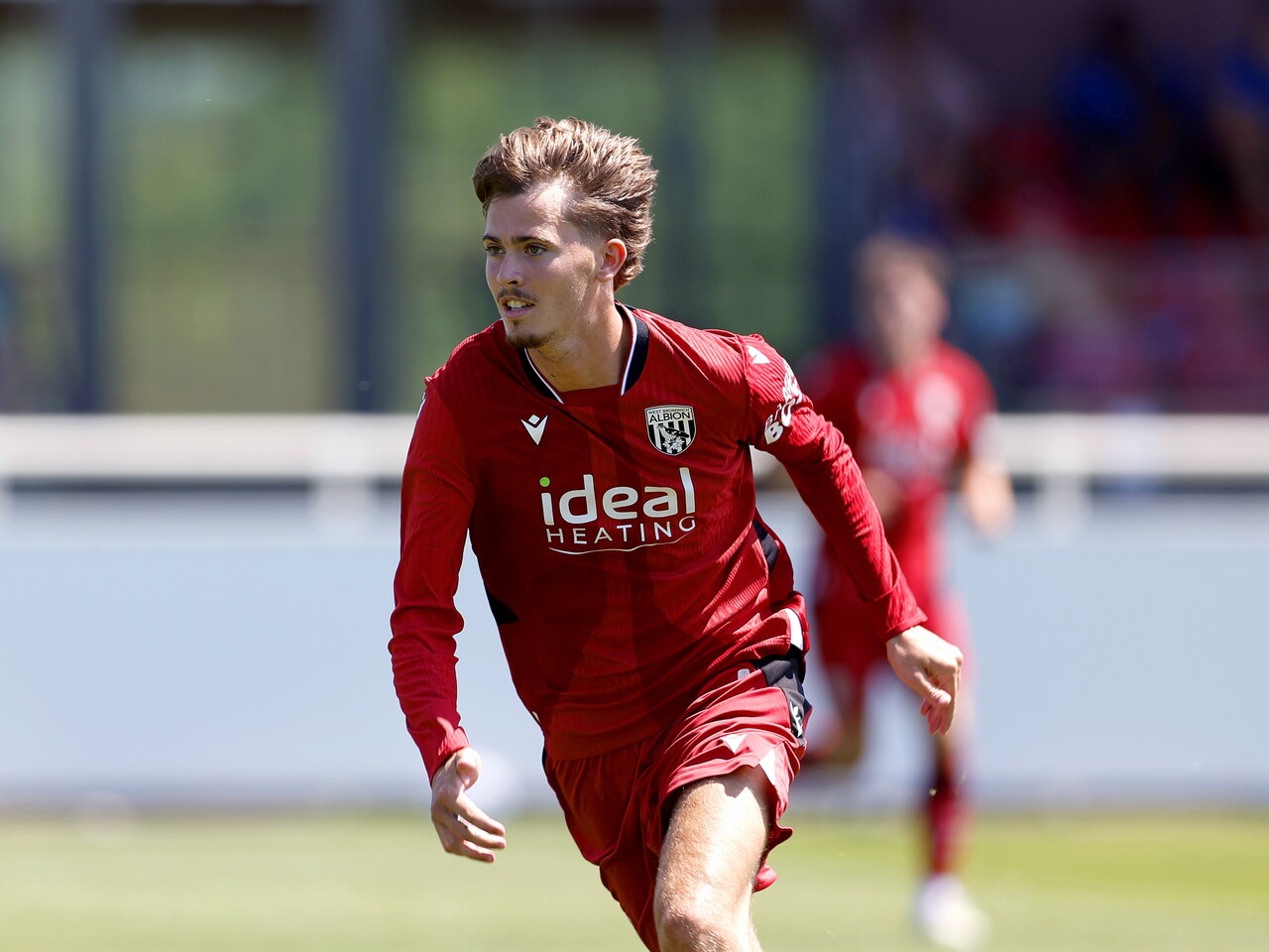Albion in action against Sheffield Wednesday in pre-season, in red away colours.