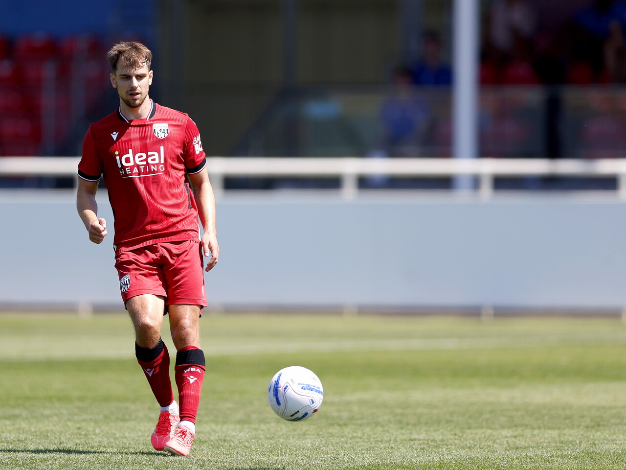 Albion in action against Sheffield Wednesday in pre-season, in red away colours.
