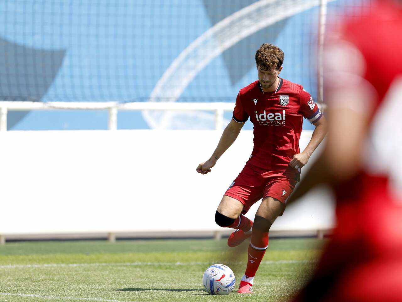 Albion in action against Sheffield Wednesday in pre-season, in red away colours.