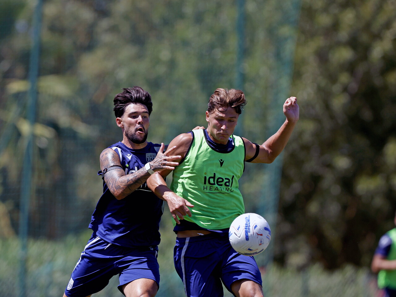 Alex Mowatt and Cole Deeming battling for the ball during a training session