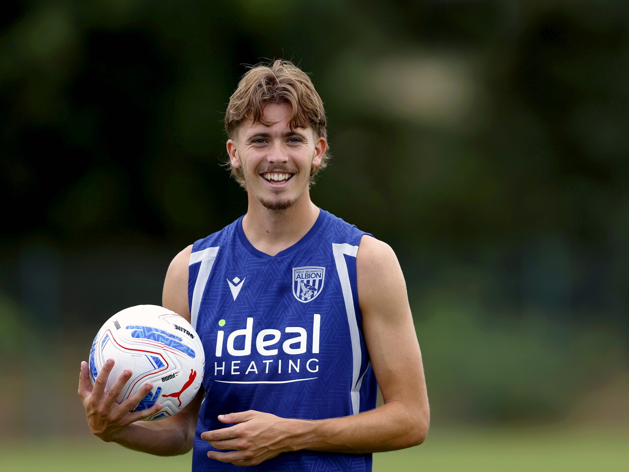 Isaac Price smiles on the training pitch in Portugal