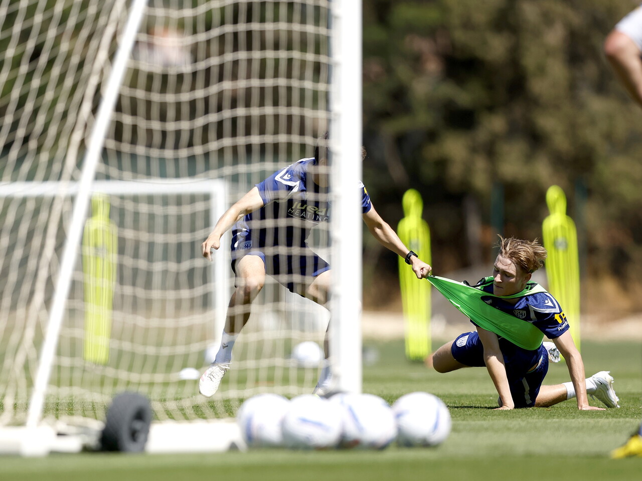 Ollie Bostock having his shirt pulled by a goal during a training session