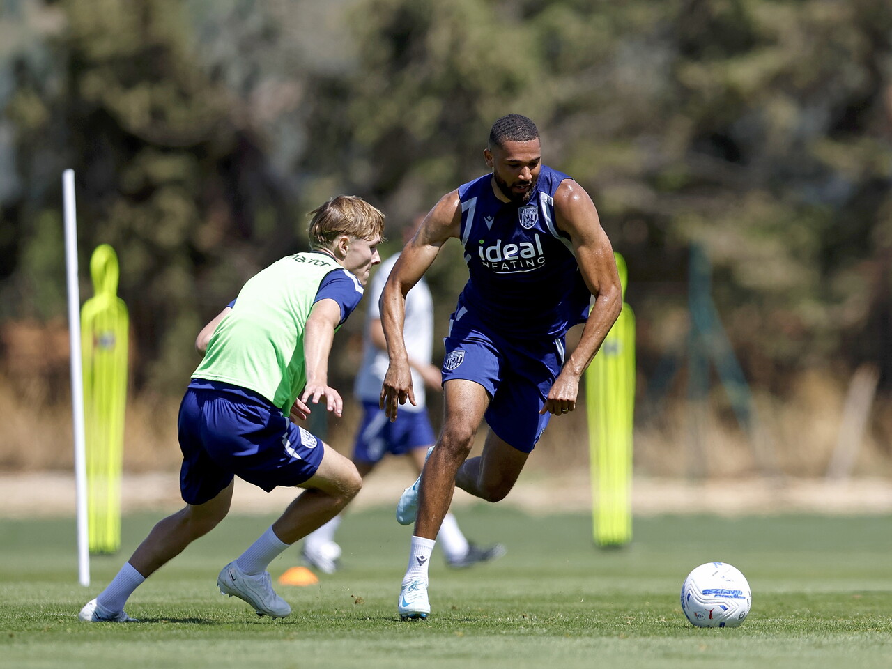 George Campbell on the ball during a training session being chased by Ollie Bostock
