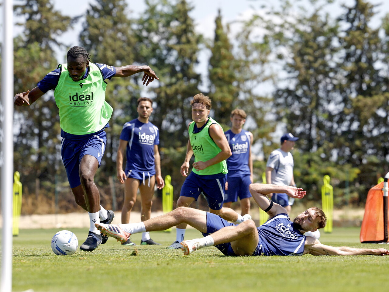 Ousmane Diakité on the ball during training, with Nat Phillips trying to make a tackle