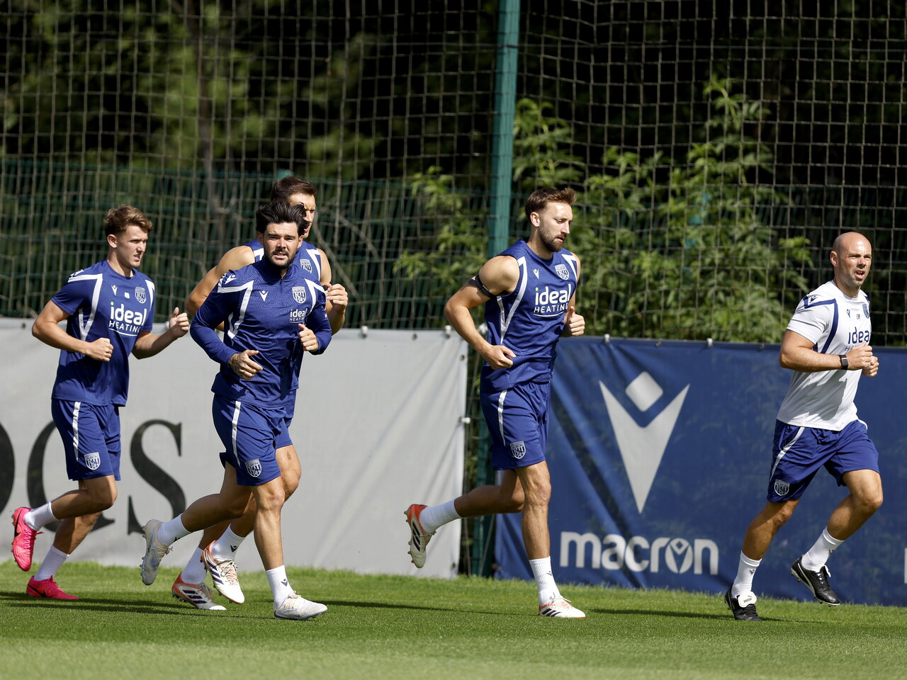 Several Albion players running during a training session