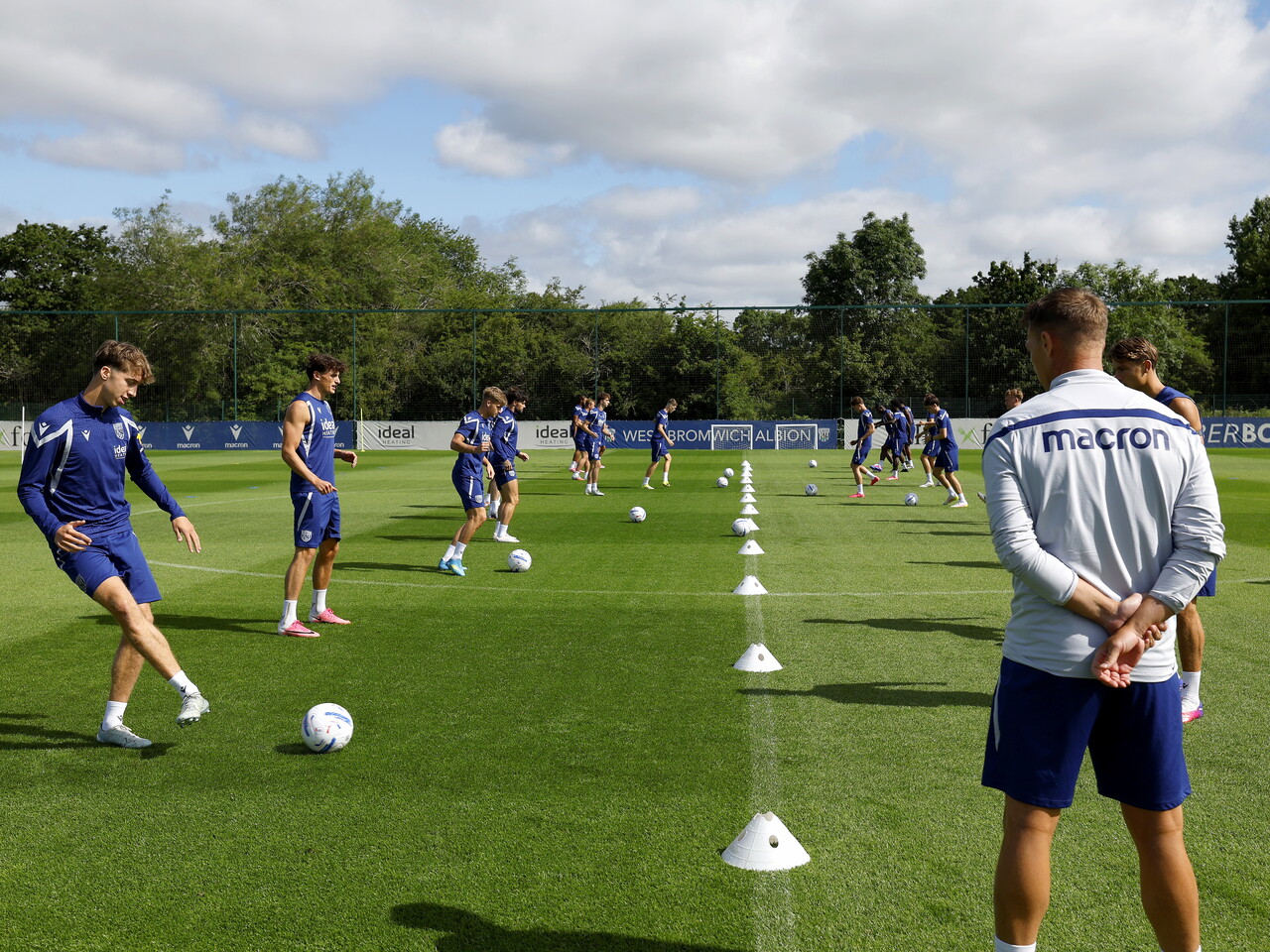 Several players completing a passing drill during training 