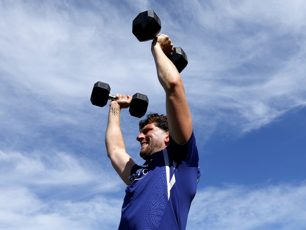Chris Mepham lifting weights above his head 