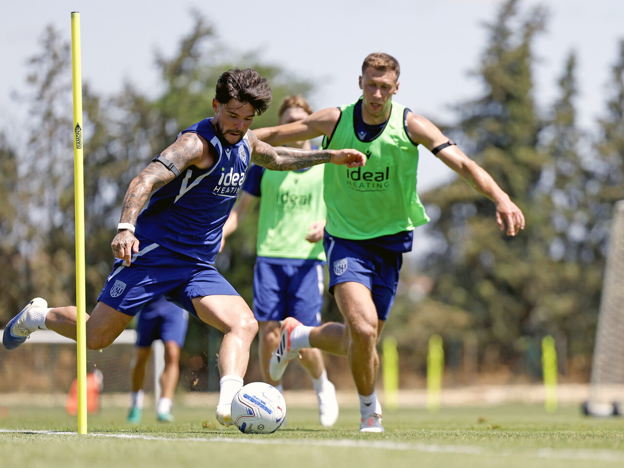 Alex Mowatt on the ball during a training session being chased by Krystian Bielik 
