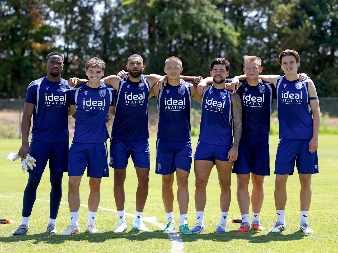 The winning team from training pose for a photo looking at the camera stood side-by-side